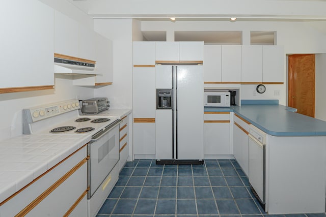 kitchen with white appliances, range hood, and white cabinetry