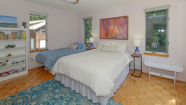 bedroom with light parquet flooring