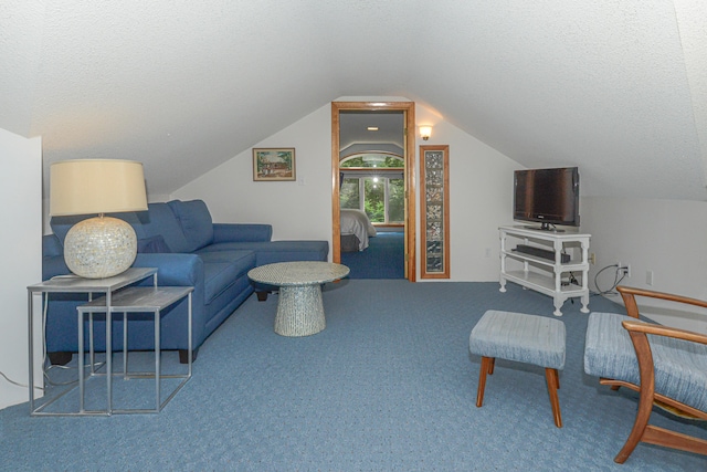 carpeted living room featuring a textured ceiling and lofted ceiling