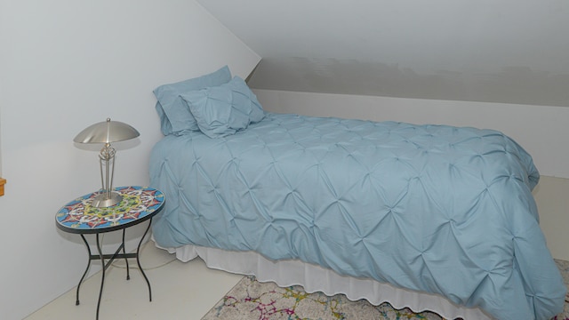 carpeted bedroom featuring vaulted ceiling