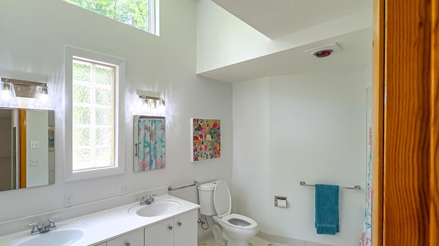 bathroom featuring vanity, toilet, and a textured ceiling