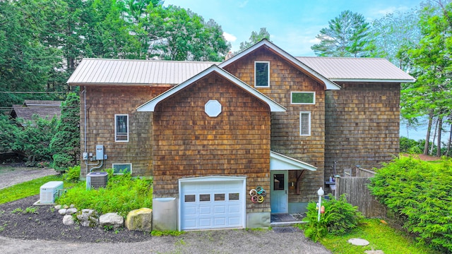 front of property with central AC and a garage