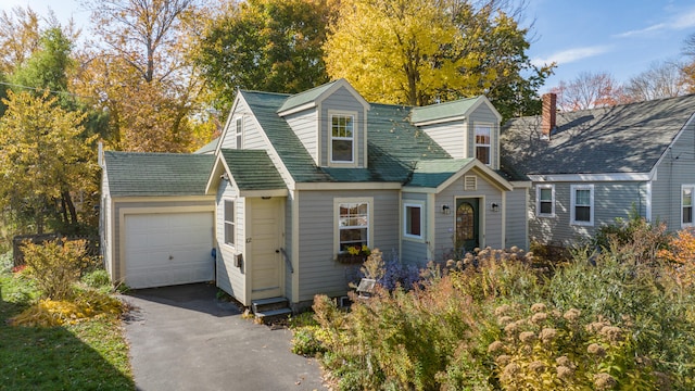 cape cod house featuring a garage