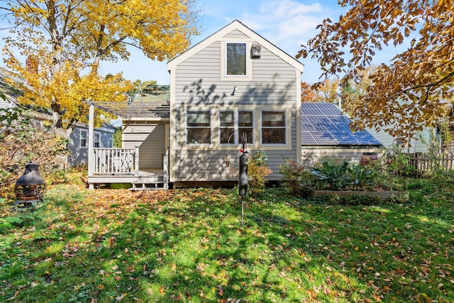 rear view of property with a pergola, a yard, and a deck