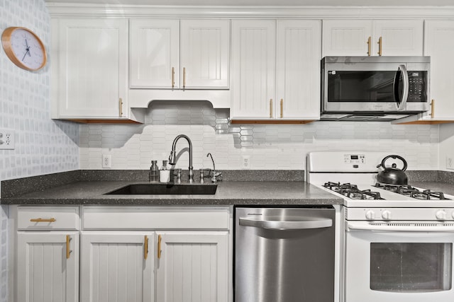 kitchen with white cabinetry, tasteful backsplash, stainless steel appliances, and sink