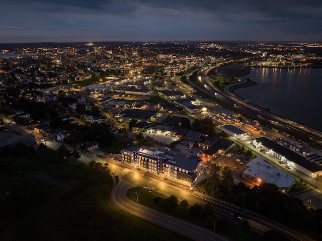 aerial view at dusk featuring a water view