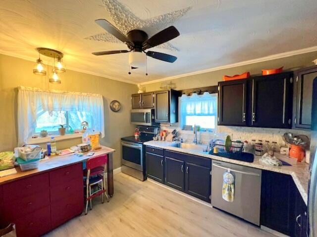 kitchen featuring ornamental molding, appliances with stainless steel finishes, light hardwood / wood-style floors, and backsplash