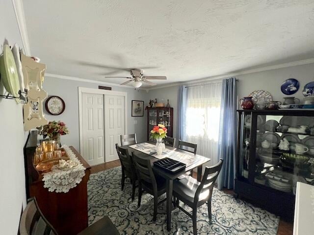 dining area with ceiling fan, wood-type flooring, a textured ceiling, and crown molding