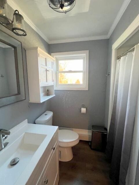 bathroom featuring toilet, vanity, wood-type flooring, and ornamental molding