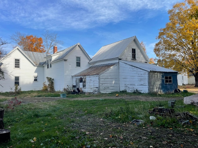 rear view of property with a yard