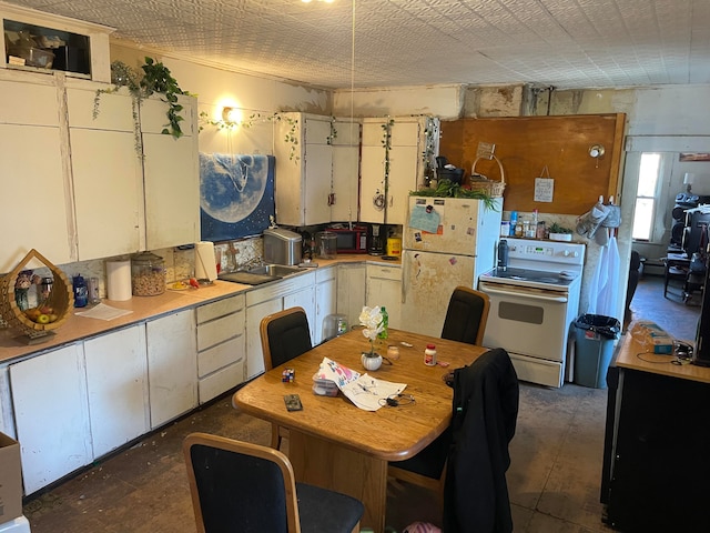 kitchen with white appliances and white cabinetry