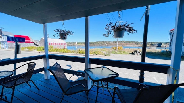 wooden terrace featuring a water view