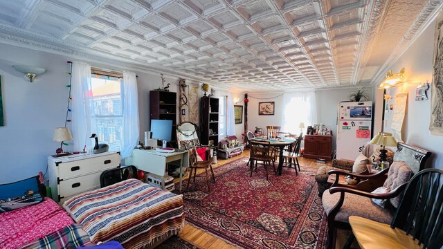 living room with ornamental molding and hardwood / wood-style floors