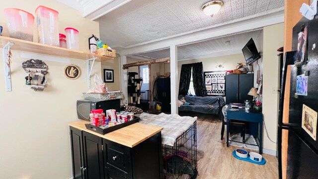 kitchen with beam ceiling and wood-type flooring