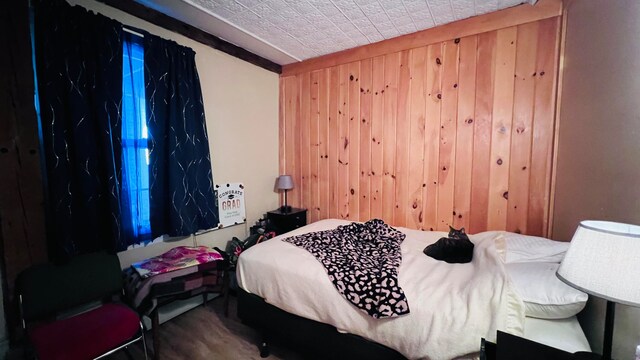 bedroom with wooden walls