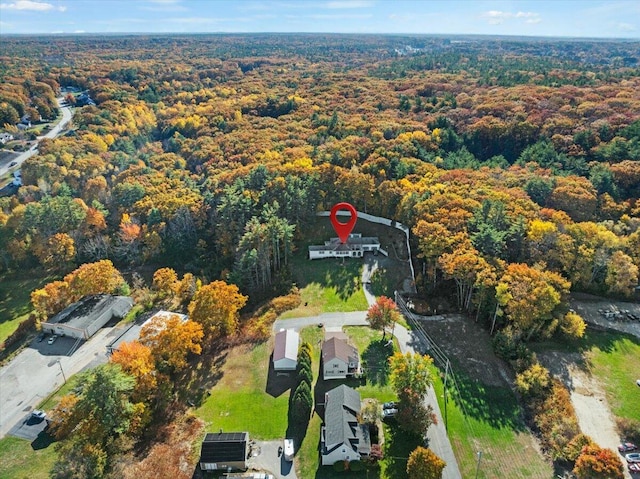 bird's eye view with a wooded view