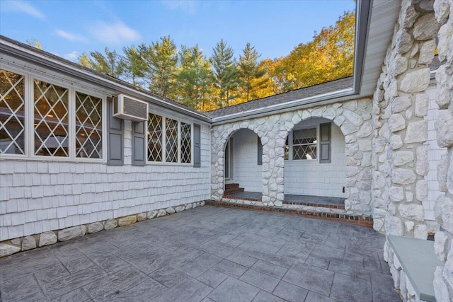 view of exterior entry with a patio area