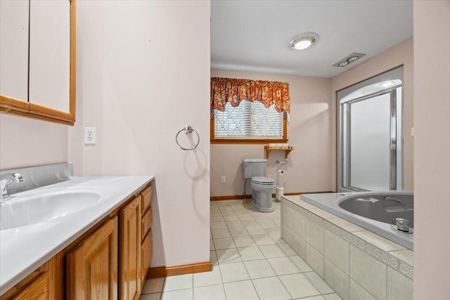 bathroom featuring tiled tub, tile patterned flooring, vanity, baseboards, and toilet