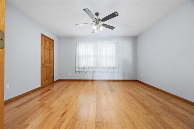 unfurnished room featuring a ceiling fan, baseboards, and light wood finished floors