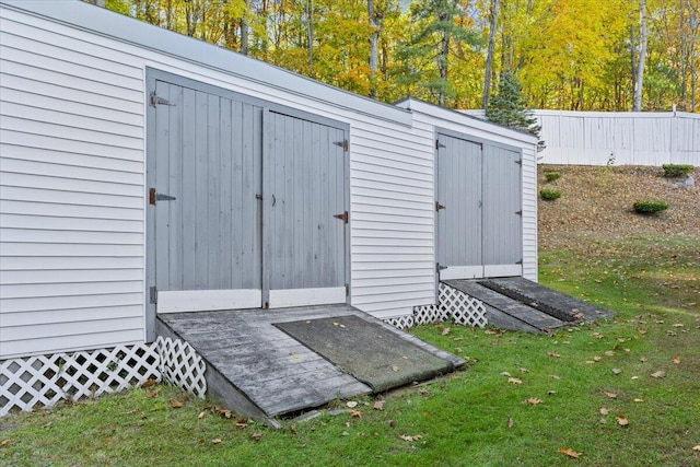 view of shed featuring fence