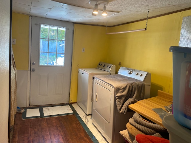 clothes washing area with independent washer and dryer and light wood-type flooring