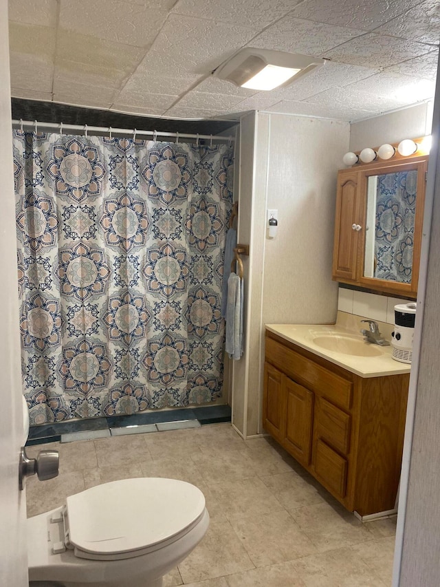 bathroom featuring vanity, toilet, and a shower with curtain