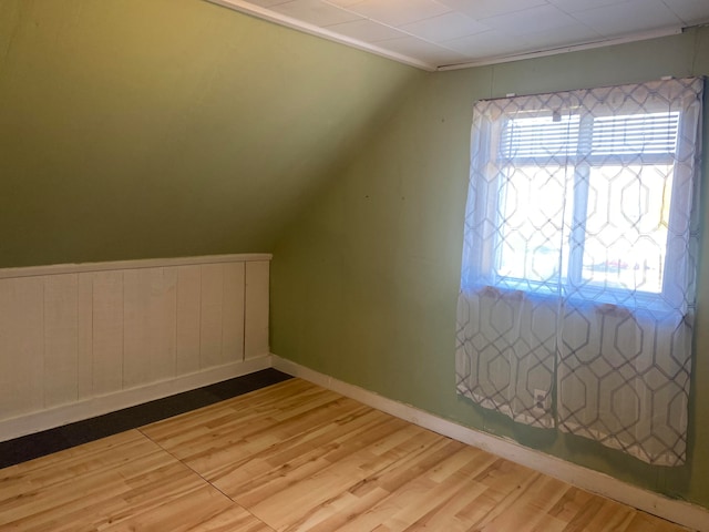 bonus room featuring light hardwood / wood-style floors and vaulted ceiling