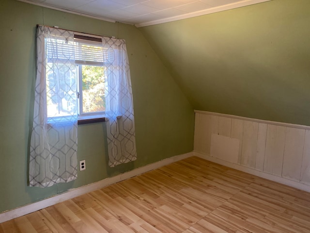 bonus room featuring vaulted ceiling and light hardwood / wood-style floors