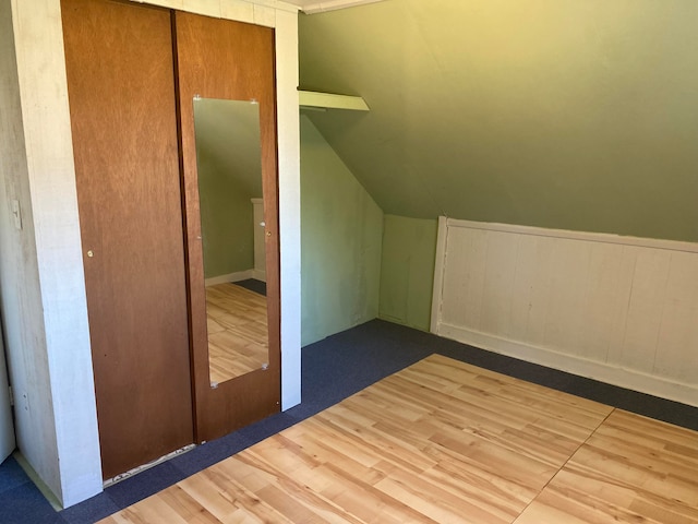 additional living space featuring lofted ceiling and wood-type flooring