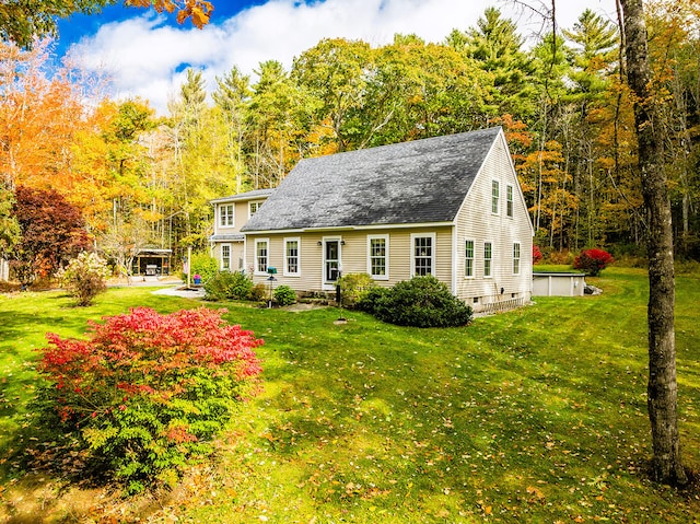 rear view of house with a yard