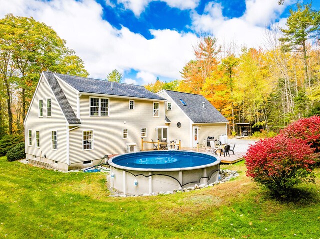 back of house featuring a patio area and a lawn