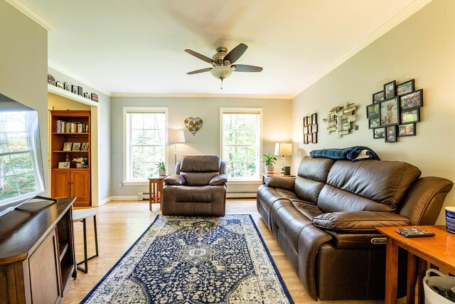 living room with crown molding, a baseboard heating unit, light wood-type flooring, and ceiling fan