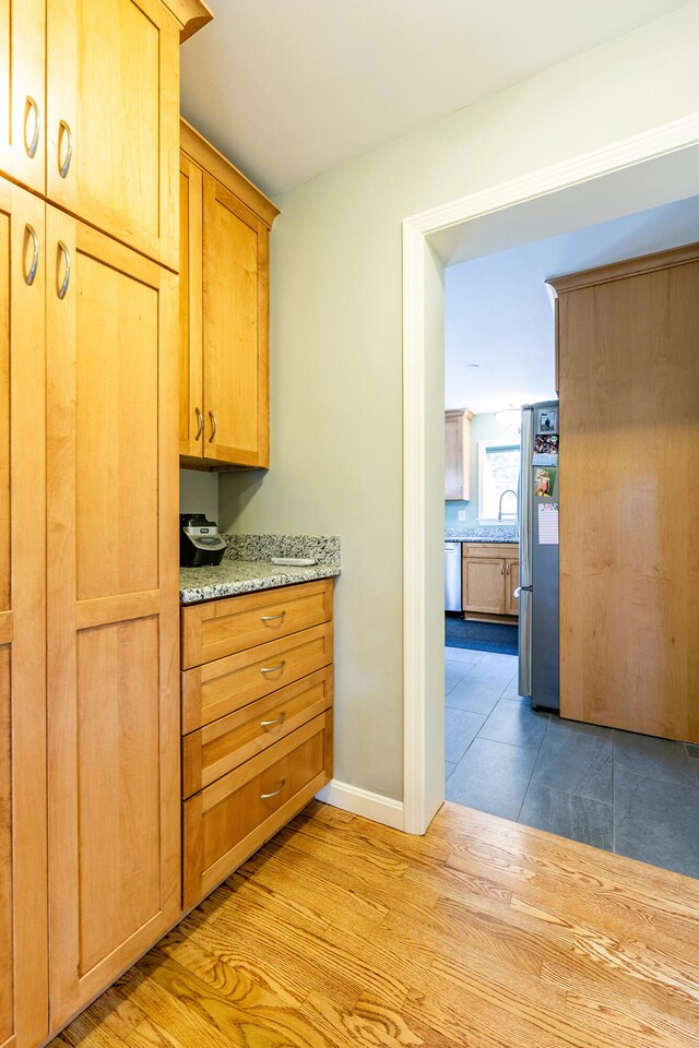 hall featuring sink and light wood-type flooring