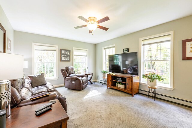 living room featuring light carpet, a baseboard heating unit, and ceiling fan