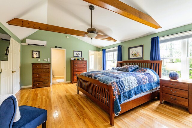 bedroom with light hardwood / wood-style flooring, lofted ceiling with beams, an AC wall unit, and ceiling fan