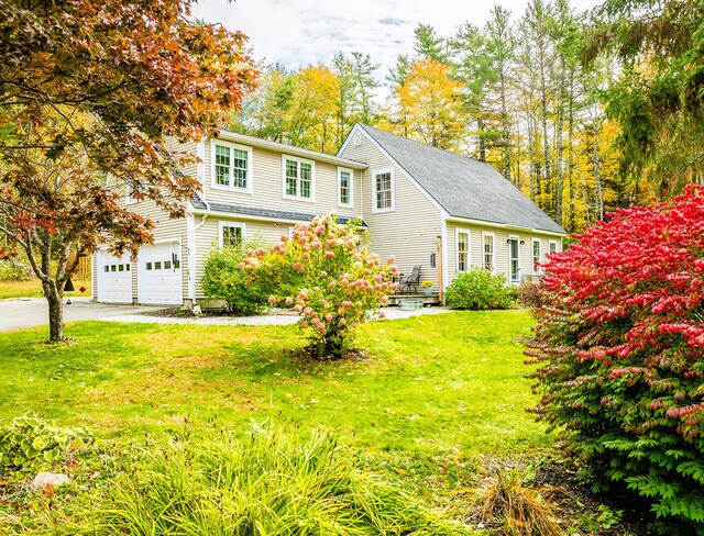 view of front of property with a front lawn and a garage