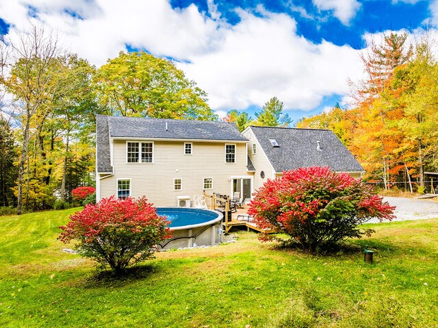 rear view of house featuring a yard