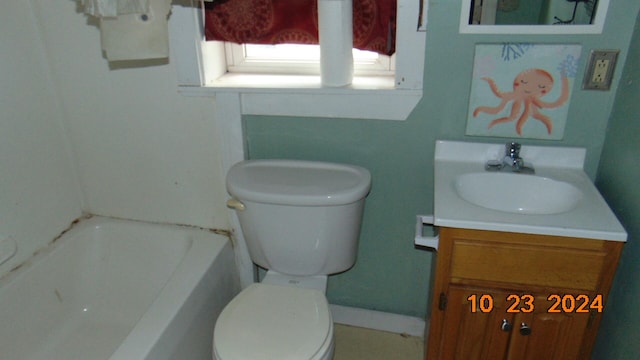 bathroom with vanity, toilet, and a washtub