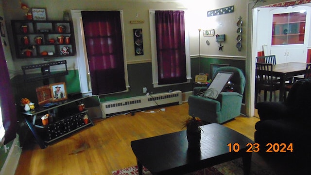 living room with hardwood / wood-style flooring and a baseboard radiator