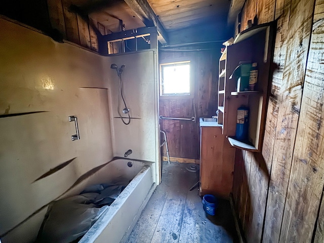 bathroom featuring wood-type flooring,  shower combination, wooden walls, and wood ceiling