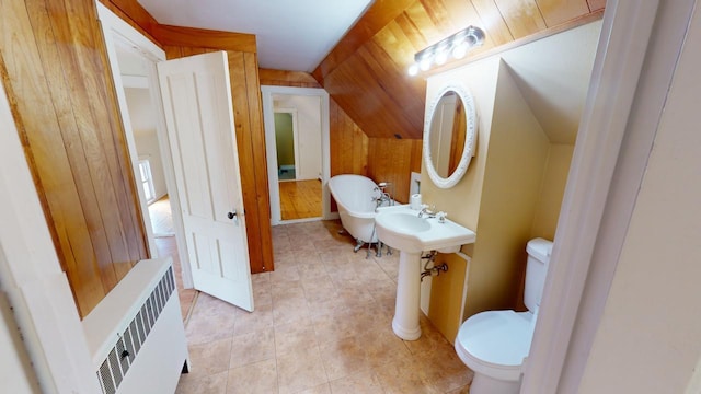 bathroom with radiator, toilet, lofted ceiling, and wooden walls