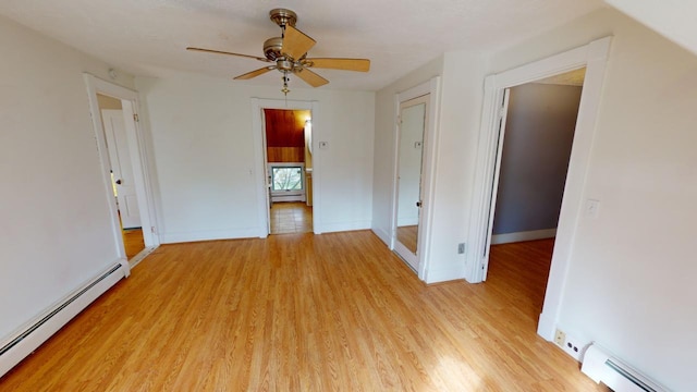 unfurnished room featuring baseboard heating, light wood-type flooring, and ceiling fan