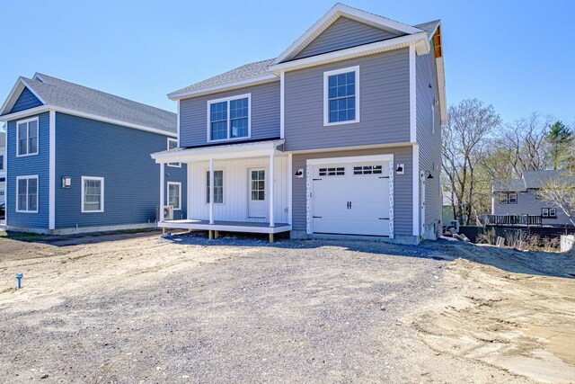 view of front of home featuring a porch and a garage