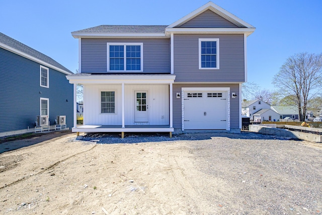 traditional-style house featuring a garage and a porch