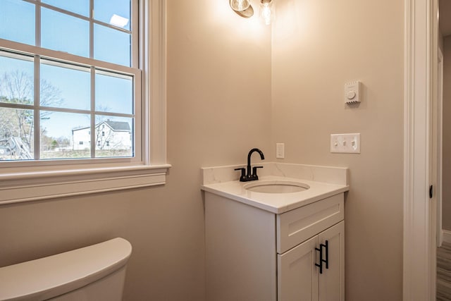 bathroom featuring vanity and toilet
