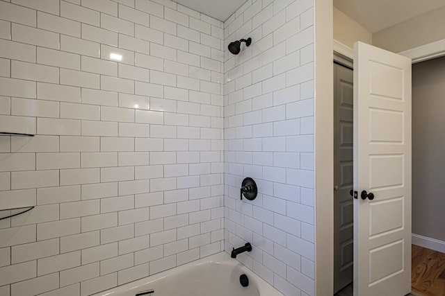 full bath featuring bathtub / shower combination and wood finished floors