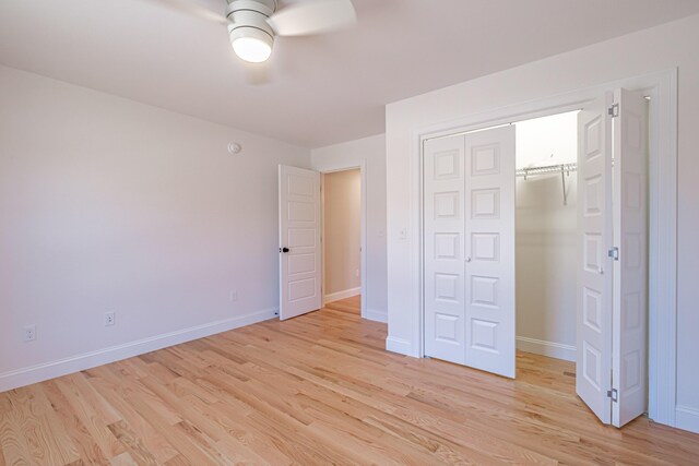 unfurnished bedroom featuring baseboards, a ceiling fan, a closet, and light wood-type flooring