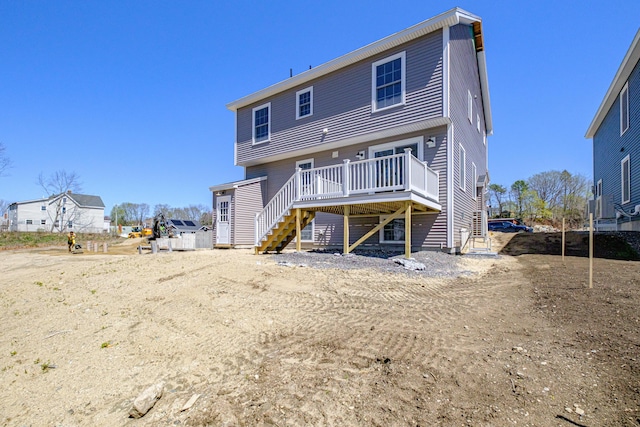 back of property with stairway and a deck