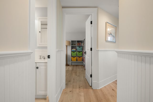 hall featuring sink and light hardwood / wood-style flooring