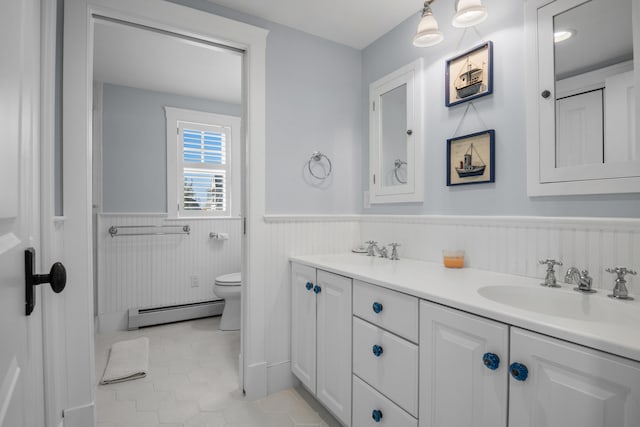 bathroom with baseboard heating, vanity, toilet, and tile patterned flooring